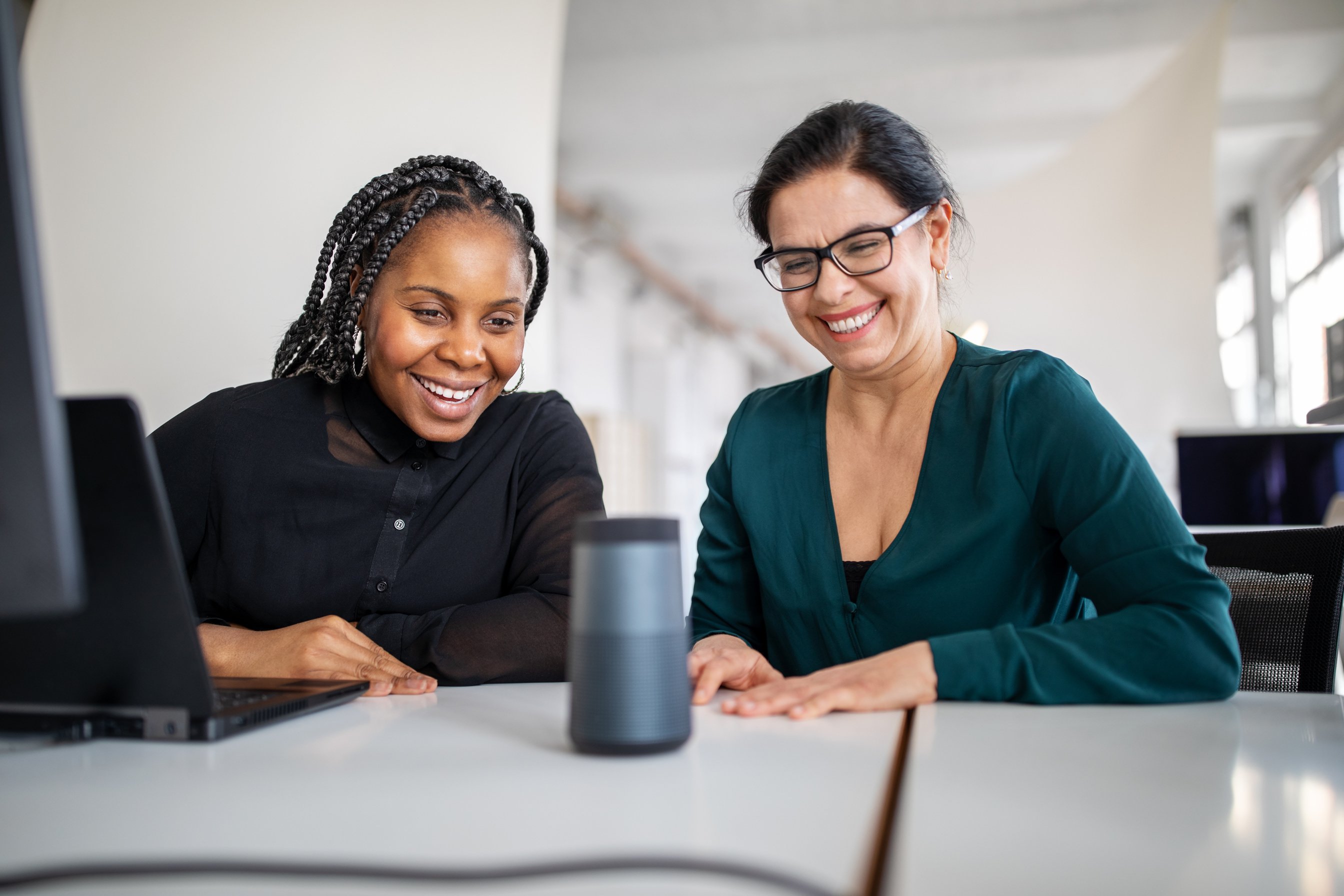 Female colleagues using virtual assistant in office